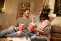 Happy couple eating popcorn at home Royalty Free Stock Photo