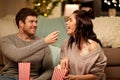 Happy couple eating popcorn at home Royalty Free Stock Photo