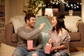 Happy couple eating popcorn at home Royalty Free Stock Photo