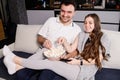 Happy couple eating popcorn and watching tv at home Royalty Free Stock Photo