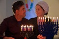 Happy couple on the eight day of Hanukkah Jewish holiday festival