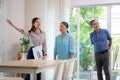 Happy couple elderly looking new home while agent real estate explaining and visit.