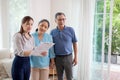 Happy couple elderly looking new home while agent real estate explaining and visit.