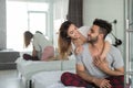 Happy Couple Embracing In Bed, Young Man And Woman Smiling Sit In Bedroom Hugging And Looking At Each Other Royalty Free Stock Photo