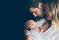 Happy couple embracing and looking newborn over Royalty Free Stock Photo