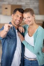 happy couple embracing while man showing key from new flat Royalty Free Stock Photo