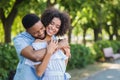 Happy couple embracing in park on sunny day Royalty Free Stock Photo