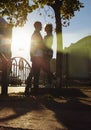 Happy couple is embracing in the street, the suns rays shine on their faces, dark background. date in the city Royalty Free Stock Photo