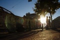 Happy couple is embracing in the street, the suns rays shine on their faces, dark background. date in the city Royalty Free Stock Photo