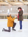 Happy couple with engagement ring on skating rink Royalty Free Stock Photo