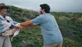 Happy couple enjoy walk on ocean coast cloudy day. Woman following man to shore.