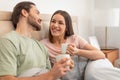 Happy couple enjoying coffee in bed, relaxed morning Royalty Free Stock Photo