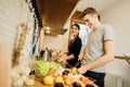 Happy couple enjoying cooking time together at home.Enjoying simple moments.Making vegan dishes.Having fun while making food, Royalty Free Stock Photo