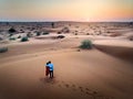 Happy couple enjoying desert sunset aerial