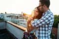 Happy couple enjoying drinks and balcony