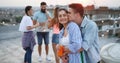 Happy couple enjoying drinks and balcony party. Royalty Free Stock Photo