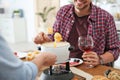 Happy couple enjoying fondue dinner at home