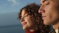 Happy couple enjoying romantic time at sea. Dreamy girl and guy with closed eyes Royalty Free Stock Photo