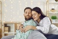 Portrait of a happy young family couple hugging and enjoying time together at home Royalty Free Stock Photo