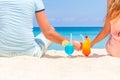 Happy couple enjoying tropical cocktails on sand beach Royalty Free Stock Photo