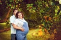 Happy couple expecting a baby walks in summer in a beautiful Par