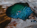 happy couple floating in waterfall lake overhead top view