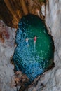 happy couple floating in waterfall lake overhead top view