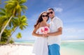Happy couple with flowers over tropical beach Royalty Free Stock Photo