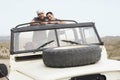 Happy Couple In Four-Wheel-Drive Car In Desert Royalty Free Stock Photo