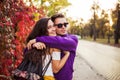 Happy couple or friends hugging on the street after encounter