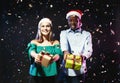 Happy couple with gift boxes at christmas party in night club Royalty Free Stock Photo