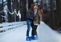 Happy couple, girl and boy ice skating outdoor at rink Royalty Free Stock Photo