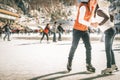 Happy couple, girls and boy ice skating outdoor at rink Royalty Free Stock Photo