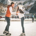 Happy couple, girls and boy ice skating outdoor at rink Royalty Free Stock Photo