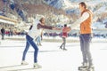 Happy couple, girls and boy ice skating outdoor at rink Royalty Free Stock Photo