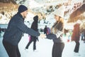 Happy couple, girls and boy ice skating outdoor at rink Royalty Free Stock Photo