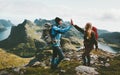 Happy couple giving five hands hiking with backpack