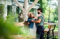 Happy couple greeting outdoors on terrace restaurant, end of lockdown. Royalty Free Stock Photo