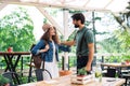 Happy couple greeting outdoors on terrace restaurant, end of lockdown. Royalty Free Stock Photo