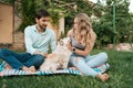 Beautiful couple with a dog on the grass