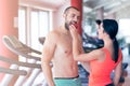 Happy couple in gym feeding each other with apple Royalty Free Stock Photo