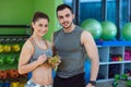 Happy couple in gym feeding each other with fresh salad Royalty Free Stock Photo