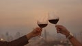 Happy couple of hand a romantic mood with red,wineglass,celebration on the rooftop