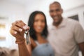 Happy couple, hands and keys for real estate purchase, property or homeowner with mortgage loan or finance. Hand of