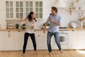 Happy couple have fun dancing together in kitchen Royalty Free Stock Photo