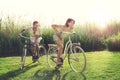 Happy Couple having a bicycles race into the nature Royalty Free Stock Photo