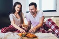 Happy couple having breakfast in bed Royalty Free Stock Photo