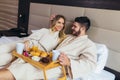 Happy couple having breakfast in luxury hotel room Royalty Free Stock Photo