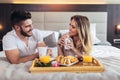 Happy couple having breakfast in luxury hotel room Royalty Free Stock Photo