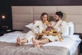 Happy couple having breakfast in luxury hotel room Royalty Free Stock Photo